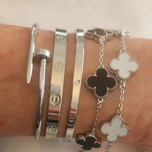 5 separate bracelets. 2 clovers 2 love and one nail. Silver stackables